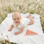 11-month wildflower meadow milestone photo with Blushing Meadows pennant