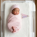 Newborn hello-world milestone photo with Little Artist pennant