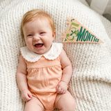 5-month milestone photo with Little Artist pennant