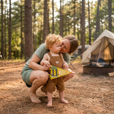 11-month milestone photo at the campsite with Little Camper pennant