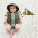 5-month milestone photo with Little Camper pennant