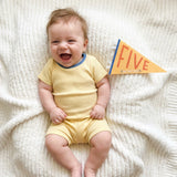 5-month milestone photo with Little Kaleidoscope pennant