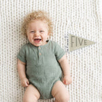 5-month milestone photo with Mountain Fields pennant