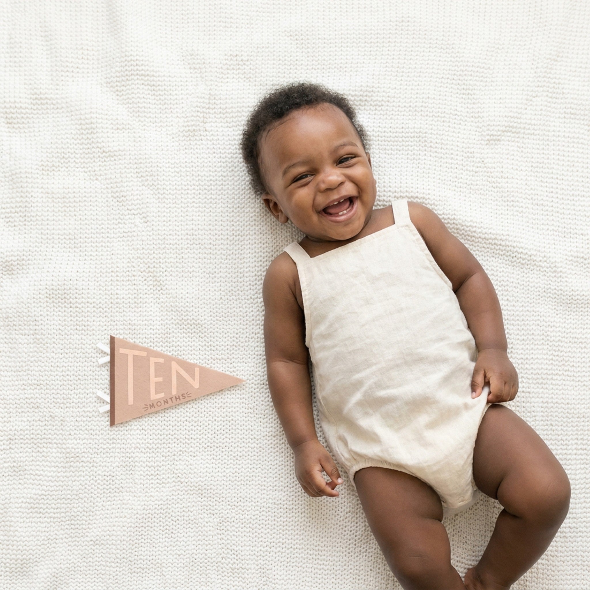 10-month milestone photo with Mountain Fields pennant